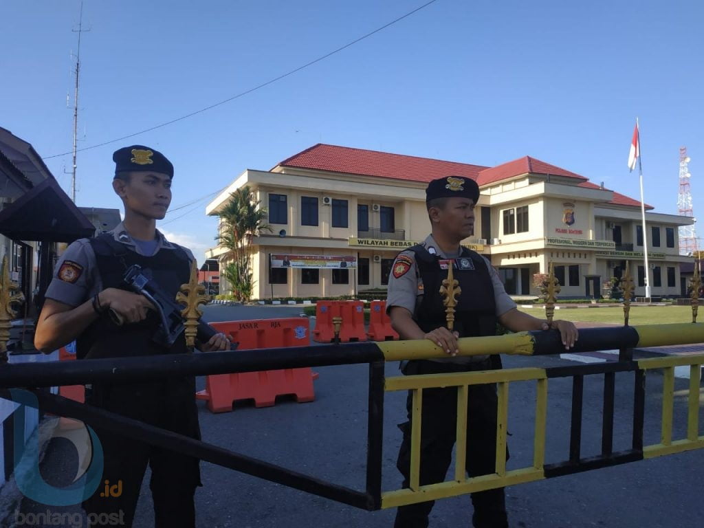 Petugas dilengkapi senjata dan rompi berjaga di depan pintu masuk Polres Bontang. (Zaenul/Bontangpost.id)