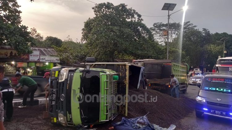 Biji sawit yang tumpah dipindahkan ke truk lain. (Lutfi/bontangpost.id)