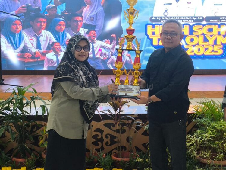 Penyerahan piala bergilir dari SMK 1 kepada Bapenda untuk diperebutkan dalam Olimpiade Pajak. (Dwi Kurniawan Nugroho / Bontang Post)