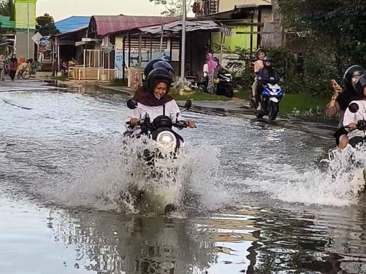 Genangan banjir rob menutupi Jalan Pierre Tendean, Kelurahan Bontang Kuala, tepat di depan SDN 001 Bontang Utara, Jumat (2/1/2026). (Nasrullah / Bontang Post)