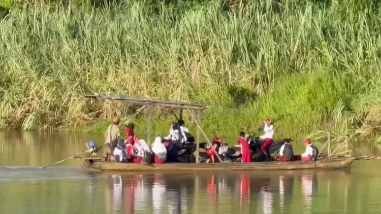 Sejumlah anak sekolah menyeberangi sungai dengan perahu di Desa Long Bentuq, Kecamatan Busang, Kutim. (IST)